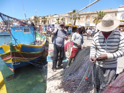 Mark helping with nets at fishing village of Marsaxlokk, Malta