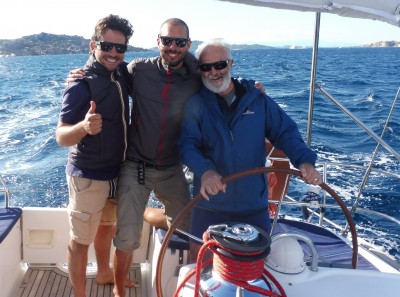 Mark at the helm with crew members Luca and Marco, Palau cruise